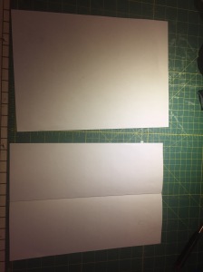 To make your pattern, take two A4 sheets of paper and fold one in half.