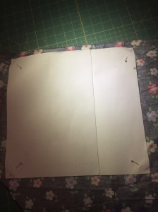Fold your fabric right side to right side.  Use your pattern piece to cut your fabric.  Don't forget to cut a notch on the right hand side, where you marked the drawstring opening.
